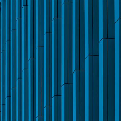 SAP S/4HANA. The side of a modern building with vertical blue panels and a clear blue sky in the background.